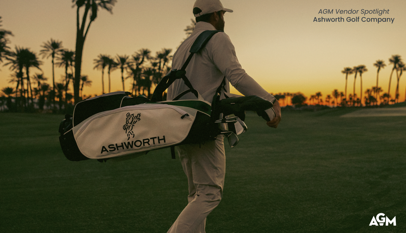 AGM Vendor Spotlight graphic featuring Ashworth Golf Company. A golfer carries a white Ashworth golf bag across a fairway at sunset, with palm trees silhouetted against an orange and gold sky in the background. Text in the upper-right corner reads: “AGM Vendor Spotlight” and “Ashworth Golf Company.” The AGM logo appears in the lower-right corner.