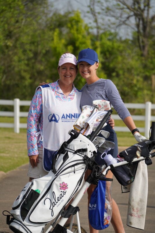 Two women standing with golf bags featuring colorful patterned headcovers from Zalea's Golf Co.