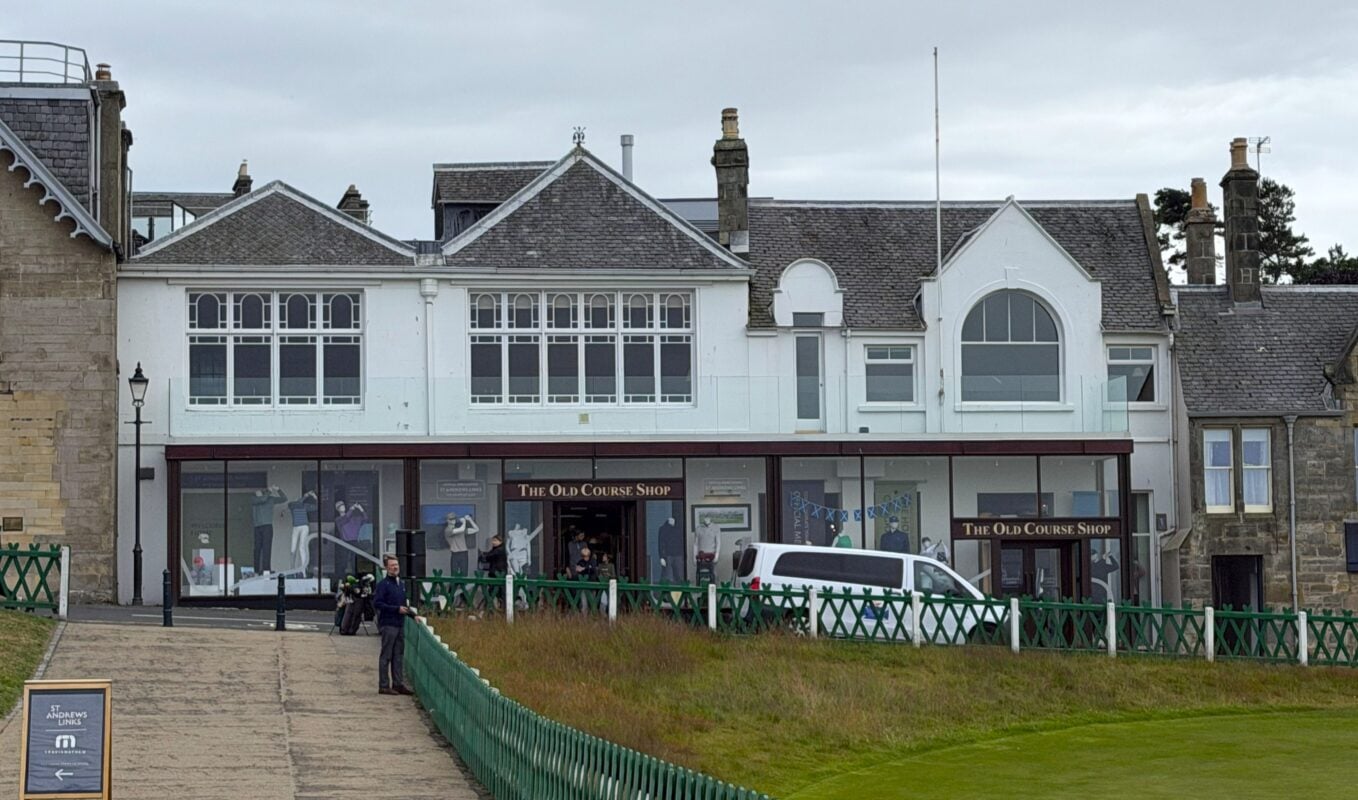 Photo of The Old Course Shop at St Andrews Links, showing the storefront beside the Old Course with merchandise displays visible through the windows.