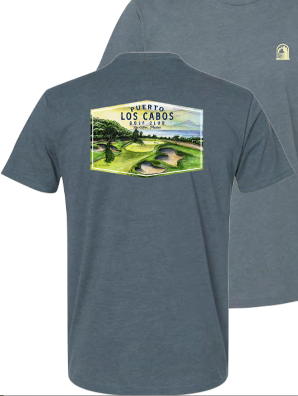 Front and back views of a slate blue Puerto Los Cabos Golf Club T-shirt, featuring a small club logo on the chest and a colorful golf course illustration on the back.