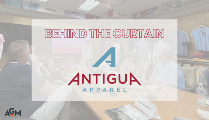 Featured graphic for the article “Behind the Curtain at Antigua,” featuring the Antigua Apparel logo over a faded photograph of AGM members attending a presentation at Antigua's facility. The AGM logo appears in the bottom left corner.