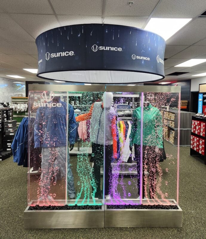 Photo of a Sunice outerwear display at Haggin Oaks, featuring colorful illuminated bubble panels, mannequins, and branded apparel.